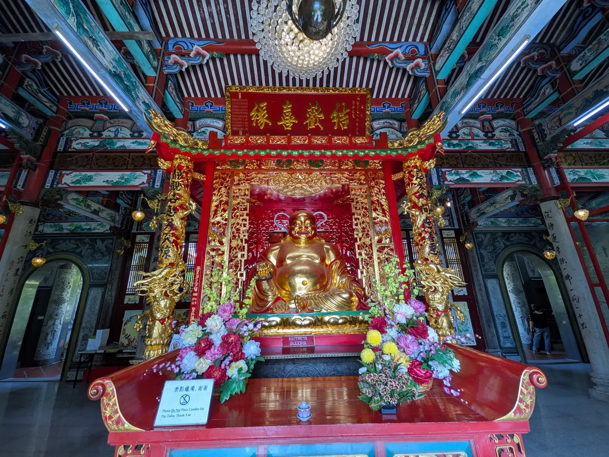 赤と金で装飾された厨子に祀られた仏像