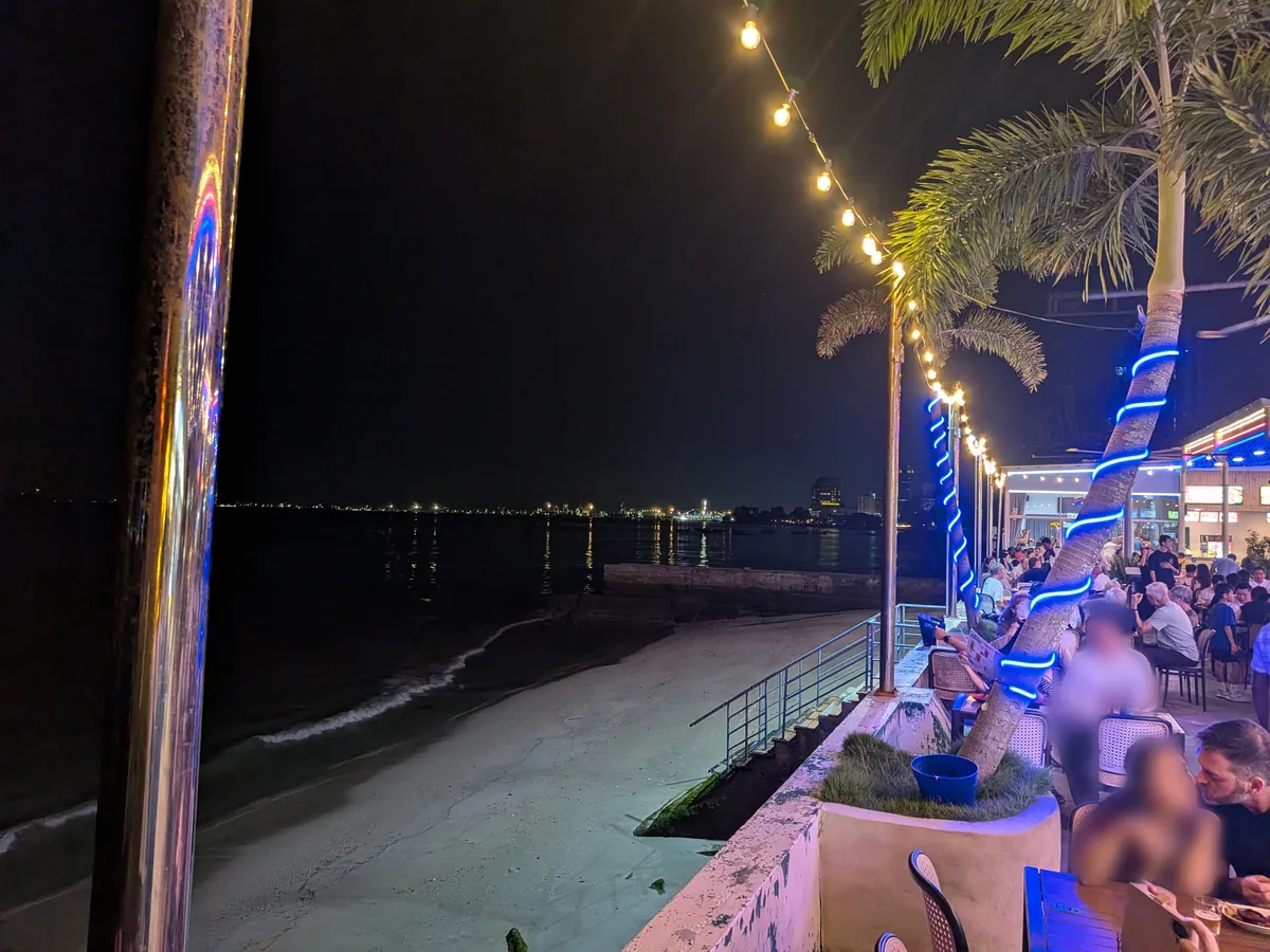 海沿いの席と夜の砂浜。ガーランドの明かりが灯る