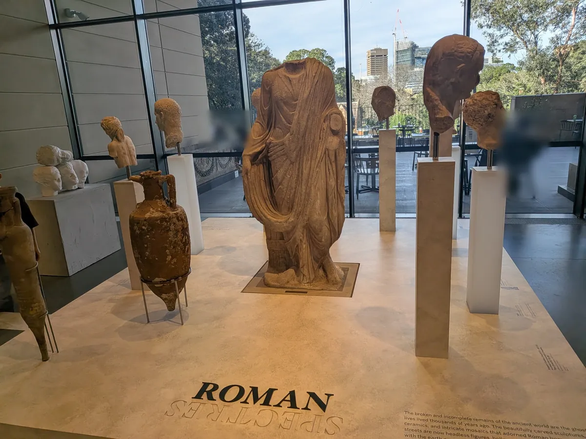 床に大きく「ROMAN SPECTRES」と記された展示室。大窓からの自然光の中に大理石の胴体像と頭部彫刻が林立している
