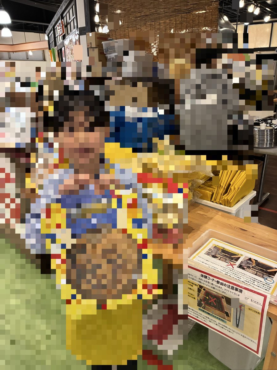 自分で作ったオリジナルせんべいが入った箱を笑顔でカメラに見せるメイ